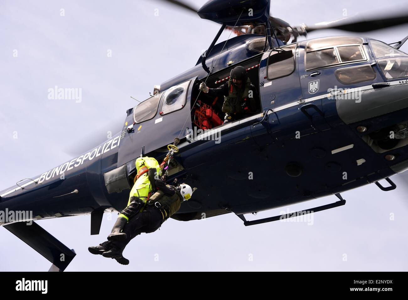 Neustadt, Germany. 17th June, 2014. A Eurocopter EC 155 helicopter lifts up a crew member of the German Federal water police ship 'Neustrelitz' at the Baltic Sea near Neustadt, Germany, 17 June 2014. The German Federal water police celebrate their 50th anniversary. Photo: CARSTEN REHDER/dpa/Alamy Live News Stock Photo