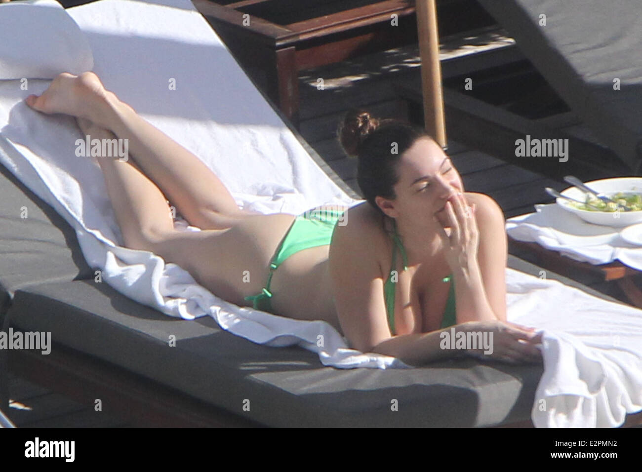 Kelly Brook shows off her stunning body as she sunbathes in a green bikini while on holiday in Miami  Featuring: Kelly Brook Where: Miami, Florida, Untied States When: 01 Feb 2013 Stock Photo