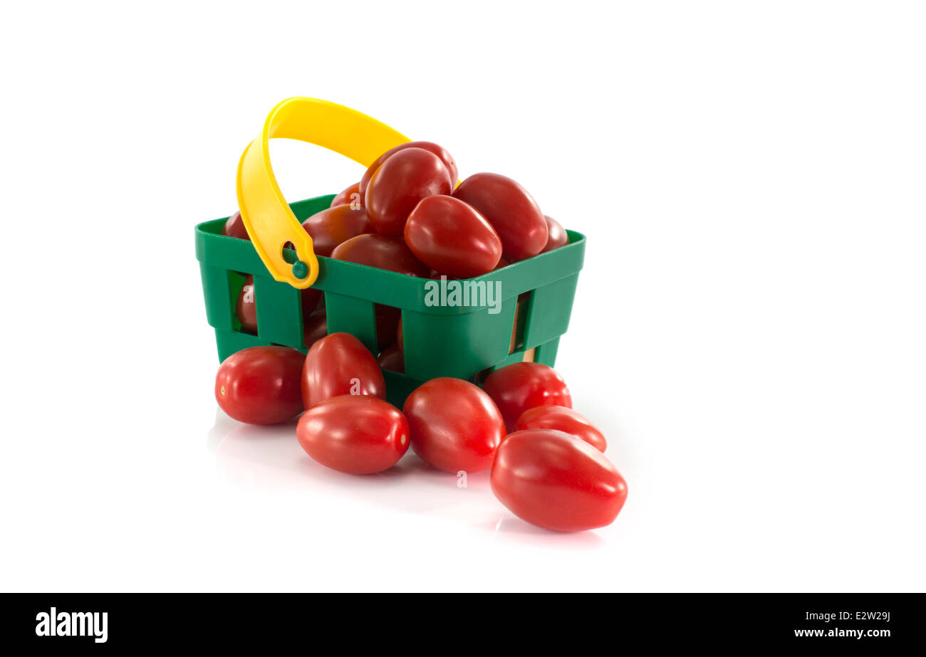 green shopping basket with red tomatoes isolated on white Stock Photo