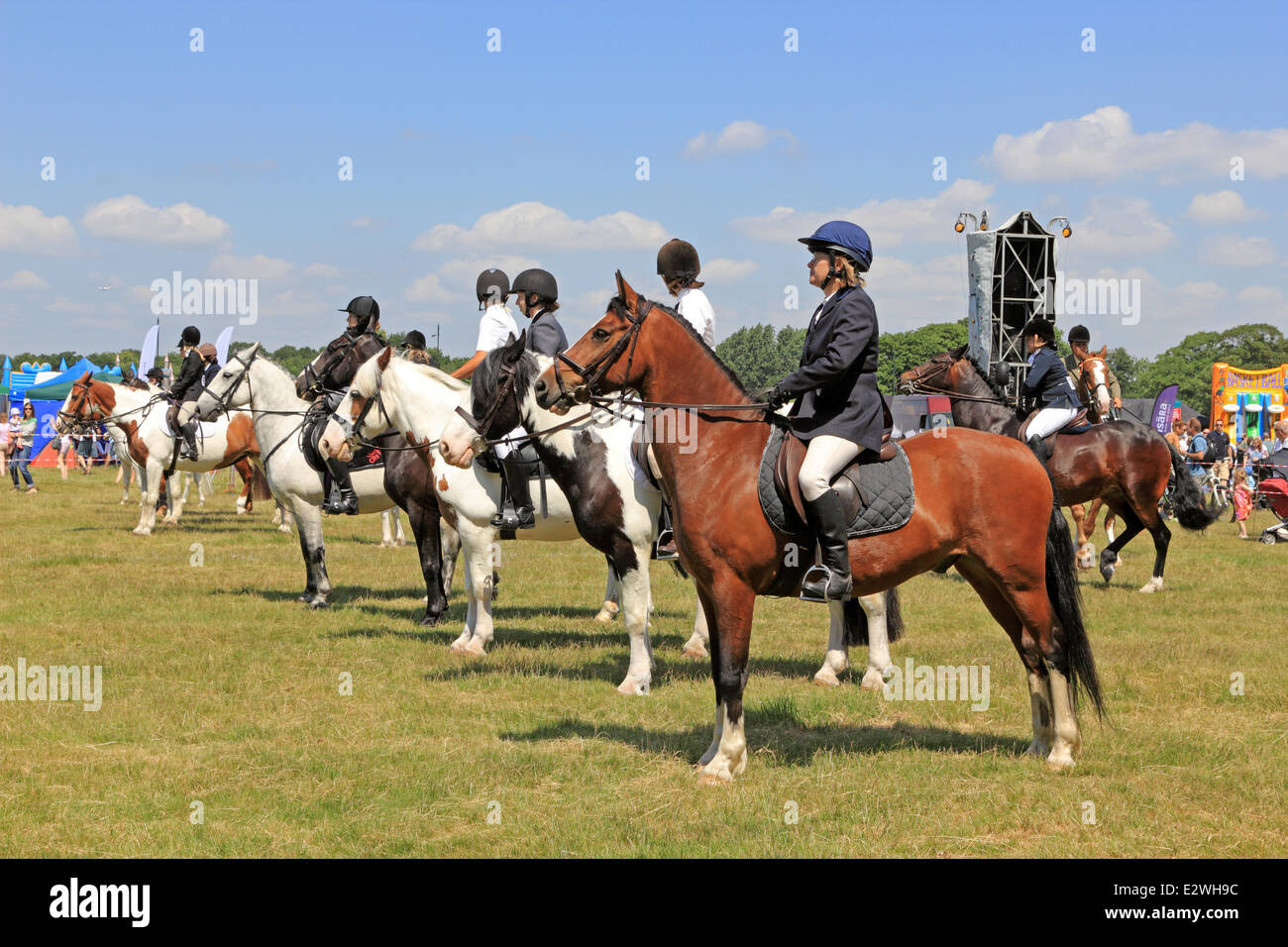 Wimbledon Common, London SW19 UK. 21st June 2014. Horses and riders line up to compete in the show ring at The Wimbledon Village Fair, an annual event attracting over 20,000 visitors. All funds raised are used to support local community projects. It is a fun day for the family with highlights including a horse show, pony rides, stalls selling a range of goods, live music and a fun fair. Credit:  Julia Gavin/Alamy Live News Stock Photo