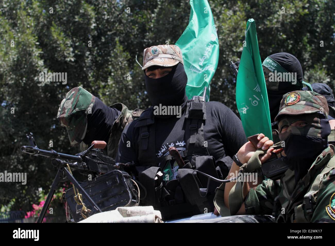 Gaza City, Gaza Strip, Palestinian Territory. 21st June, 2014. Palestinian members of the Ezzedine al-Qassam Brigades, the military wing of Hamas, attend the funeral of comrades who died two days ago after an explosion caused the collapse of a tunnel under the Israeli border, on June 21, 2014, in Gaza City. In addition to tunnels dug under the border with Egypt to smuggle goods, militant Gaza groups use tunnels to infiltrate beyond Israel's lines Credit:  Mohammed Asad/APA Images/ZUMAPRESS.com/Alamy Live News Stock Photo