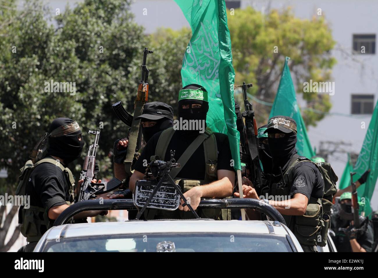 Gaza City, Gaza Strip, Palestinian Territory. 21st June, 2014. Palestinian members of the Ezzedine al-Qassam Brigades, the military wing of Hamas, attend the funeral of comrades who died two days ago after an explosion caused the collapse of a tunnel under the Israeli border, on June 21, 2014, in Gaza City. In addition to tunnels dug under the border with Egypt to smuggle goods, militant Gaza groups use tunnels to infiltrate beyond Israel's lines Credit:  Mohammed Asad/APA Images/ZUMAPRESS.com/Alamy Live News Stock Photo