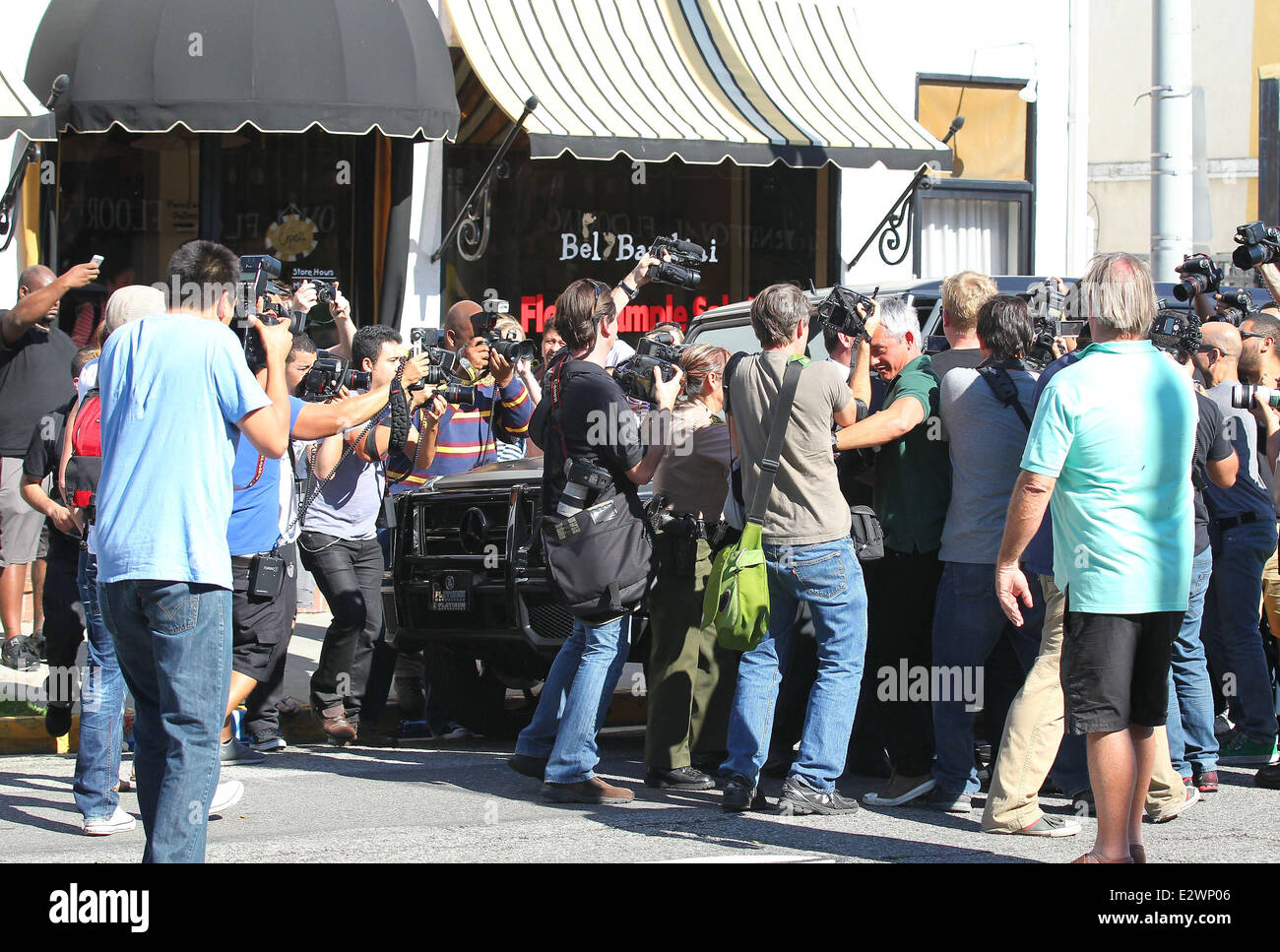 Kim Kardashian is surrounded by photographers as she gets into her