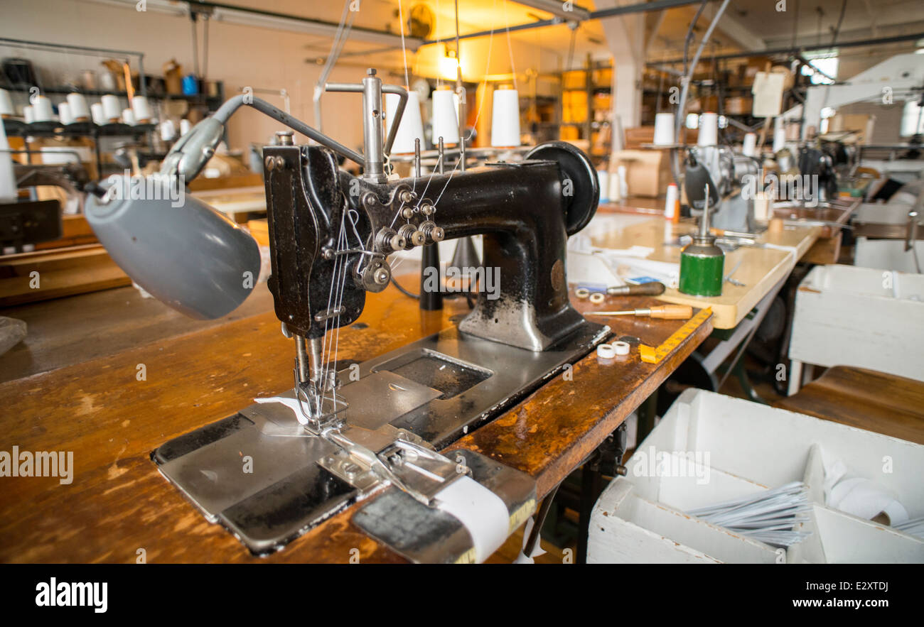 A black Singer sewing machine attached to an antique table sits in a corset factory in Cortland, NY. Stock Photo
