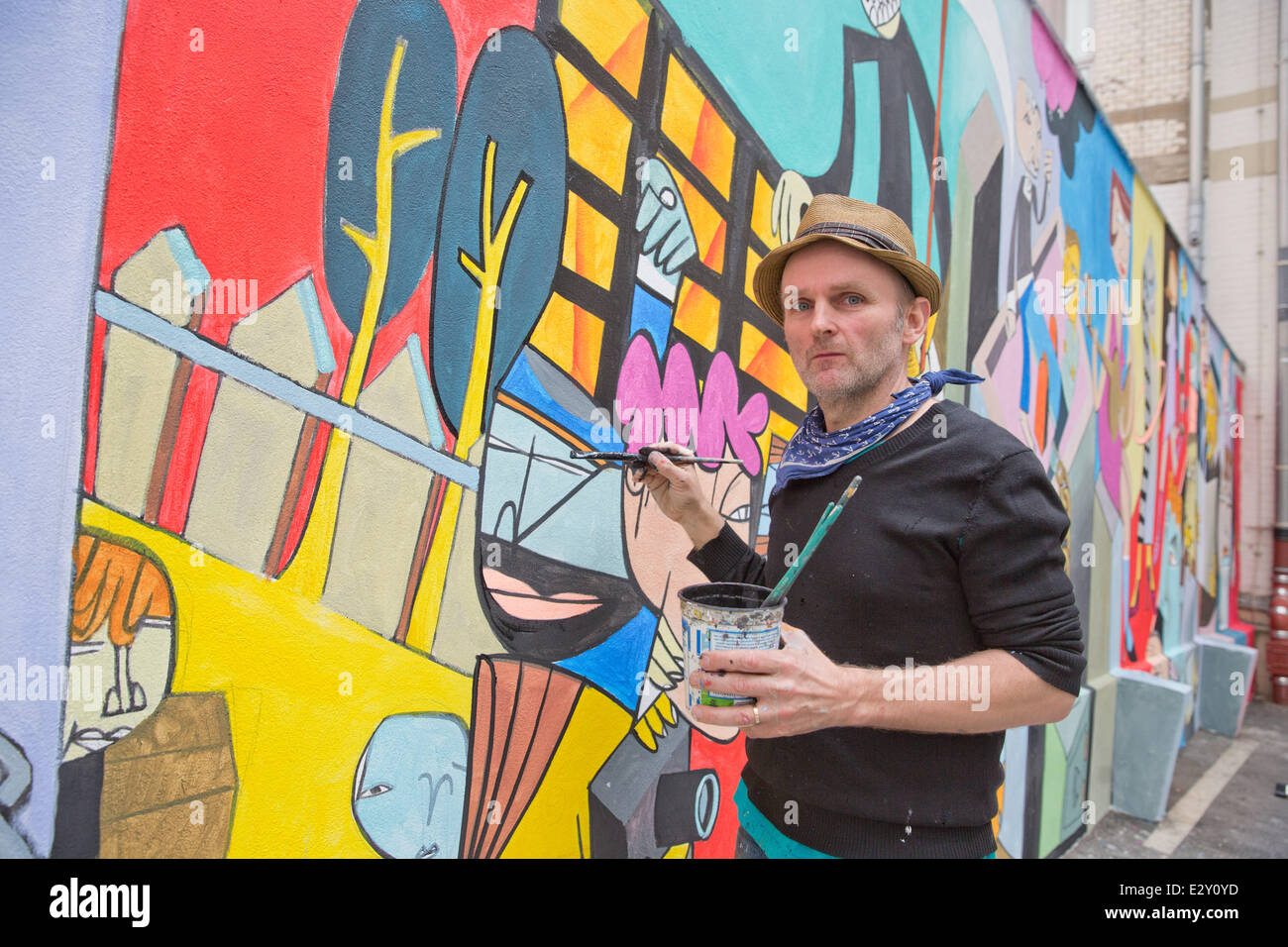 The artist Jim Avignon paints a wall picture in the patio of the Tagesspiegel in Berlin, 21 June 2014. The newspapaer Tagesspiegel invites during the open day from 11 am until 20pm. Photo: Joerg Carstensen/dpa Stock Photo