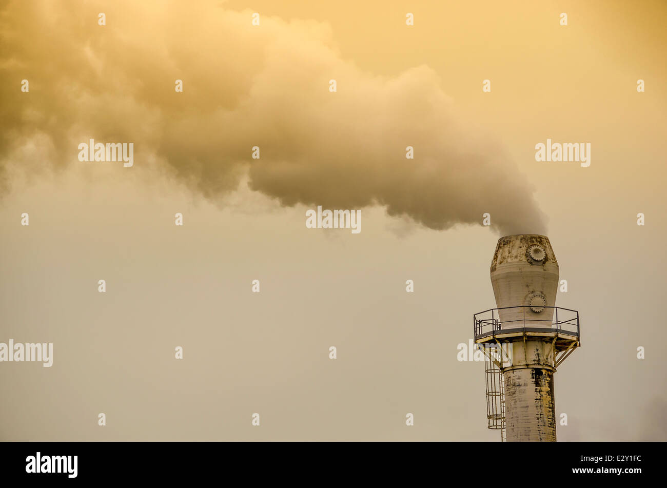 Yellow smoke from factory pipe Stock Photo