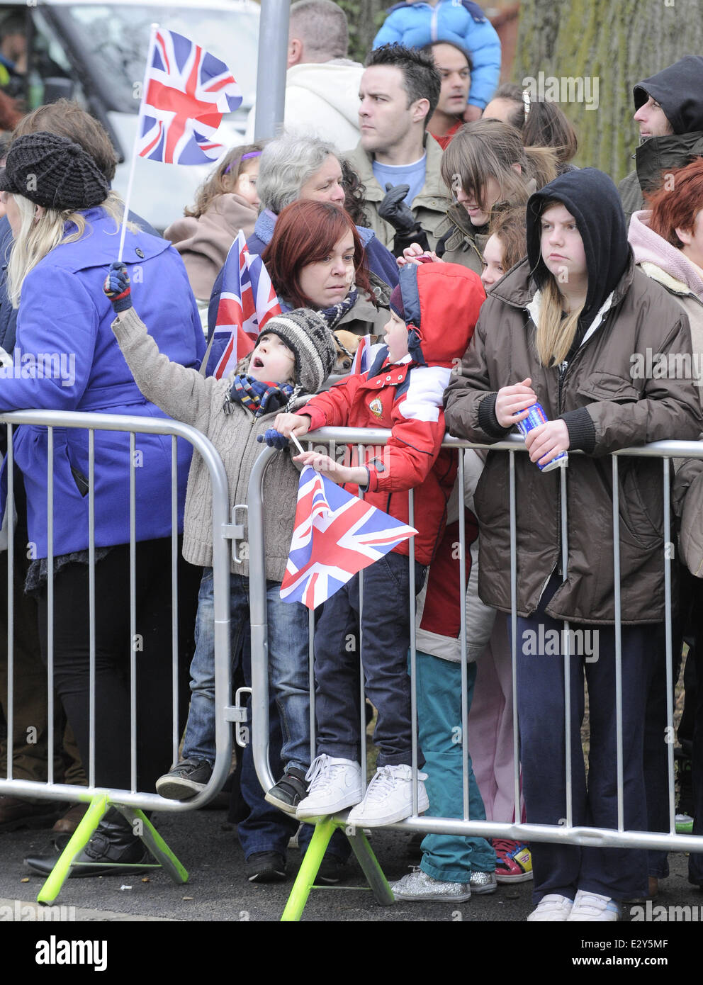 Members of the public wait to catch a glimpse of Queen Elizabeth II as