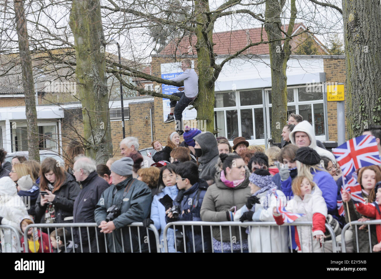 Members of the public wait to catch a glimpse of Queen Elizabeth II as