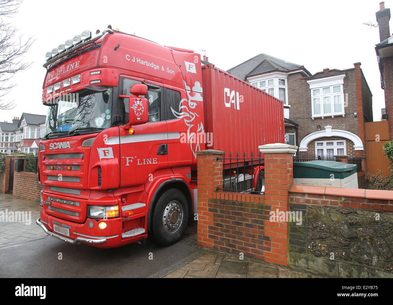 Boxes are loaded into a shipping container at the North Korean Embassy