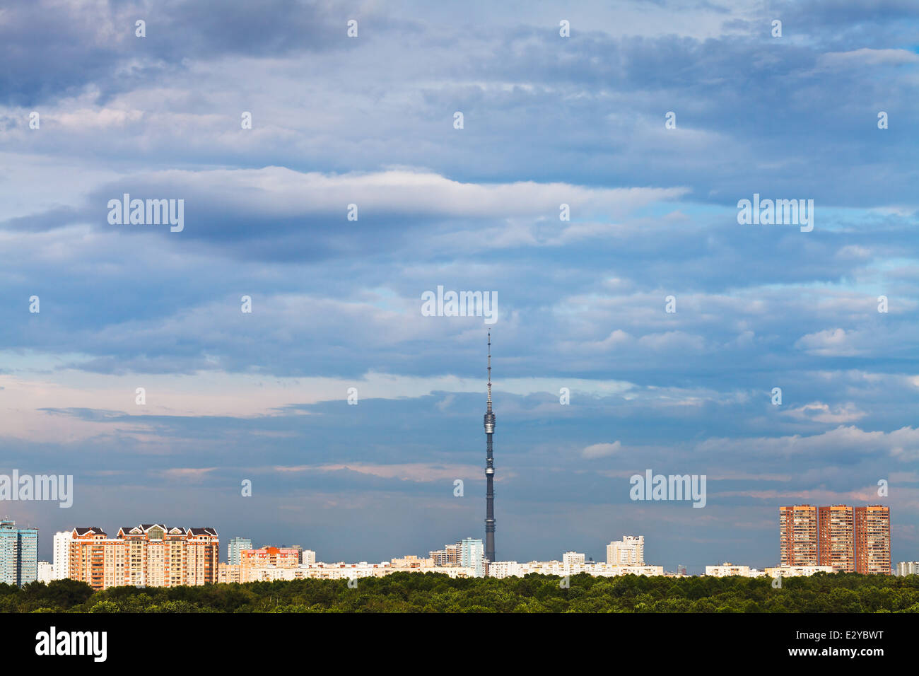 blue clouds in sunset sky over city in summer evening Stock Photo - Alamy