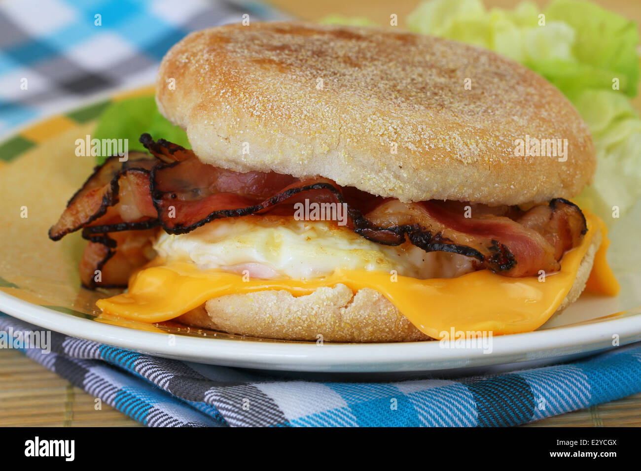 Muffin with fried egg, bacon and cheese Stock Photo