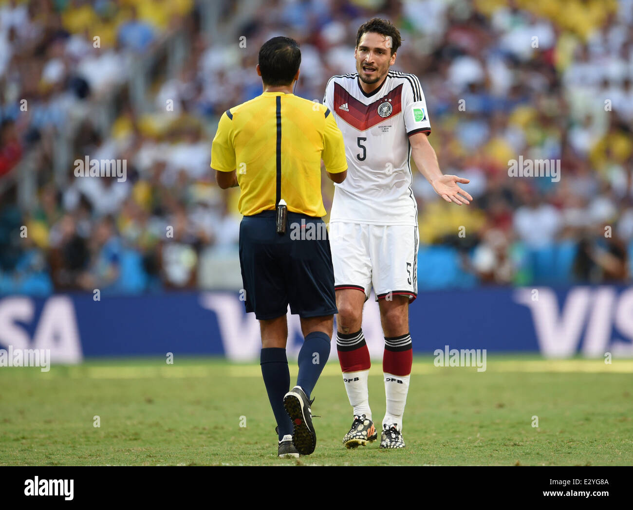 Fortaleza, Brazil. 21st June, 2014. Germany's Mats Hummels (R) talks to referee Sandro Ricci during the FIFA World Cup 2014 group G preliminary round match between Germany and Ghana at the Estadio Castelao Stadium in Fortaleza, Brazil, 21 June 2014. Photo: Andreas Gebert/dpa/Alamy Live News Stock Photo