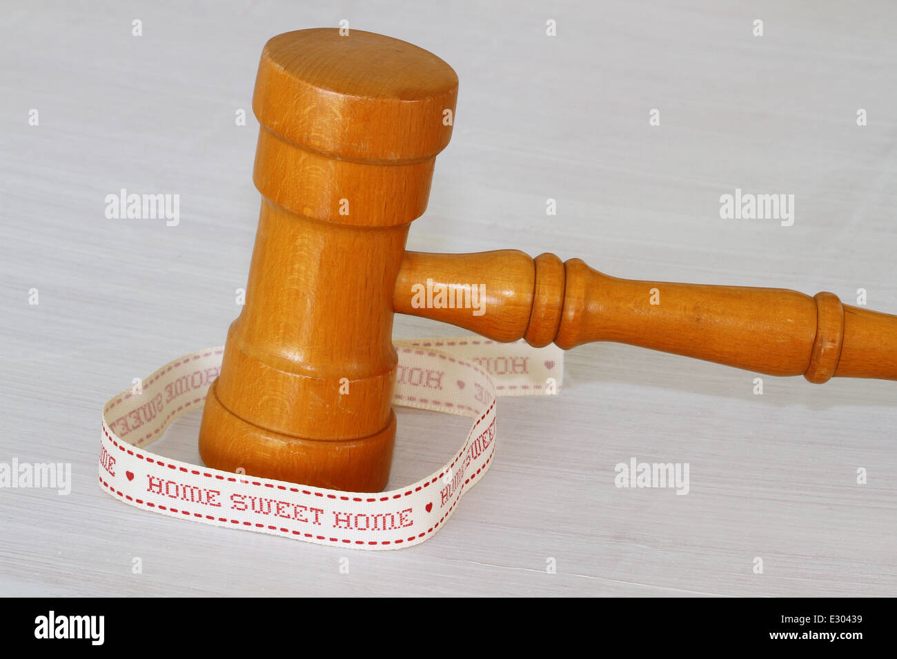 Auction hammer with 'home sweet home' ribbon Stock Photo
