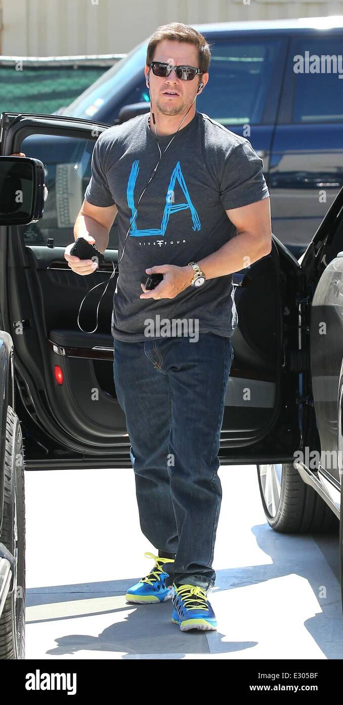 Mark Wahlberg wearing Los Angeles T-Shirt, Blue Jordan CP3.VI with Bose headphones and Iphone while out shopping in Beverly Hills  Featuring: Mark Wahlberg Where: Los Angeles, CA, United States When: 19 Apr 2013 Stock Photo