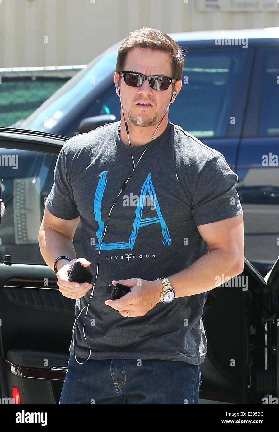 Mark Wahlberg wearing Los Angeles T-Shirt, Blue Jordan CP3.VI with Bose  headphones and Iphone while out shopping in Beverly Hills Featuring: Mark  Wahlberg Where: Los Angeles, CA, United States When: 19 Apr