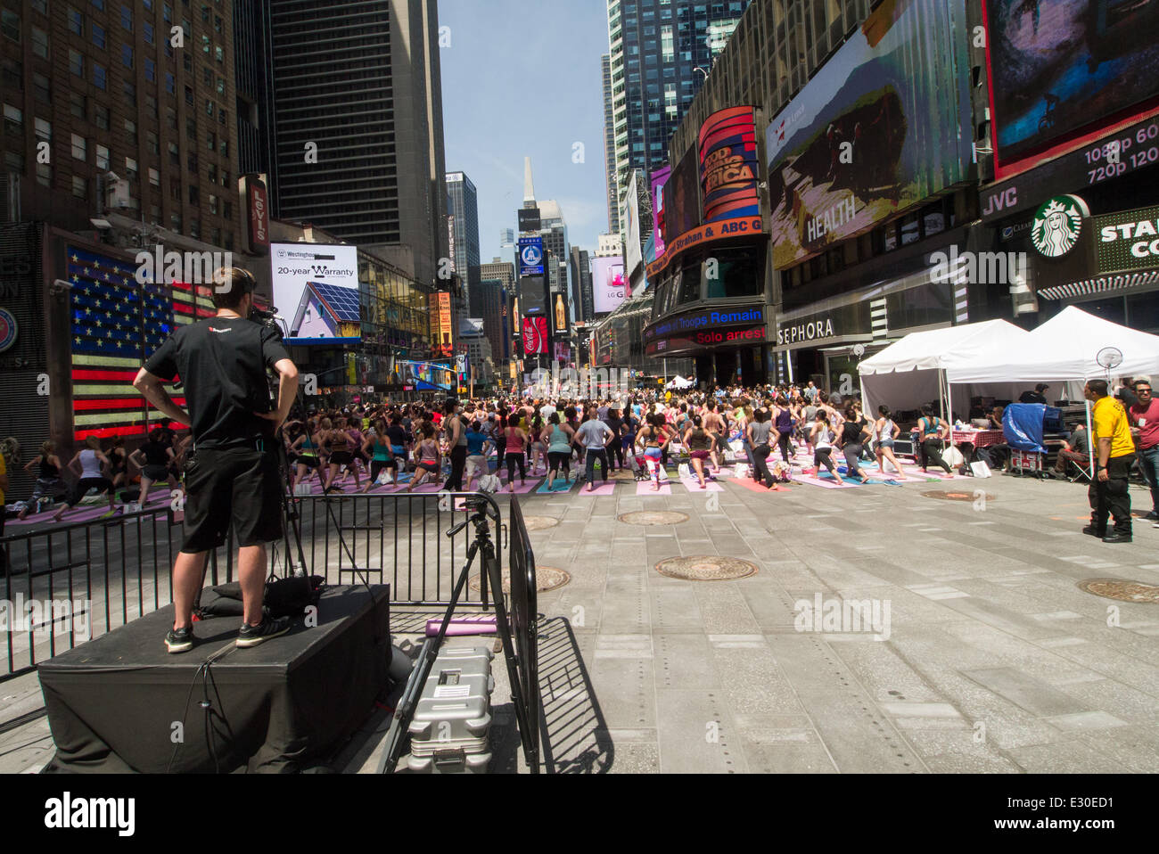 NEW YORK, NY - JUNE 21:  New Yorkers are marking the first day of summer by practicing Yoga in Times Square during the 12th annual Solstice in Times Square on June 21, 2014 in New York City.  (Photo by Donald Bowers) Stock Photo