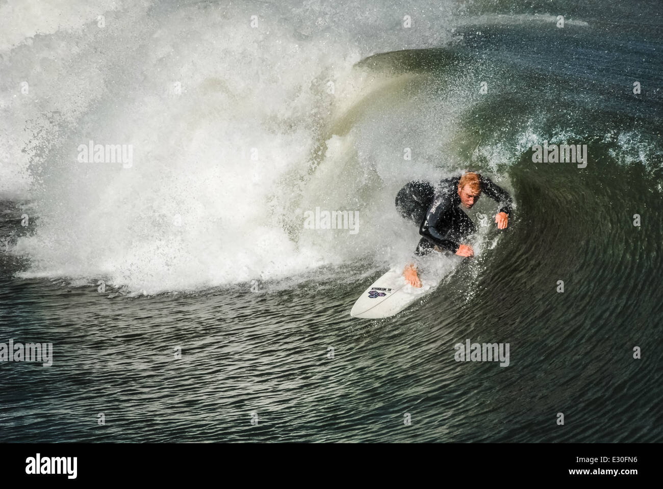 Jacksonville Beach, Florida surfer ducks under the pitching lip of a tubing wave Stock Photo Alamy