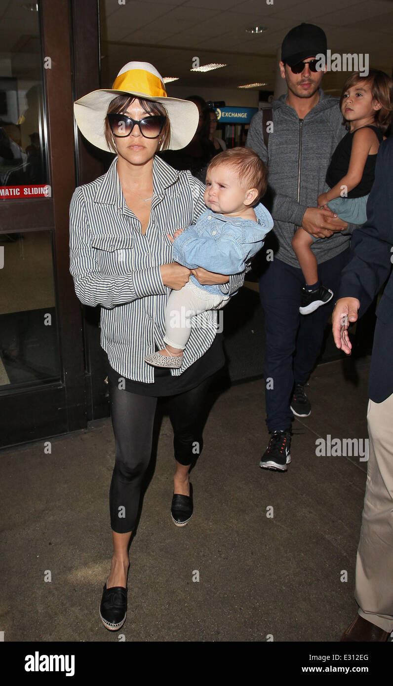 Kourtney Kardashian and Scott Disick arrive back into LAX with their