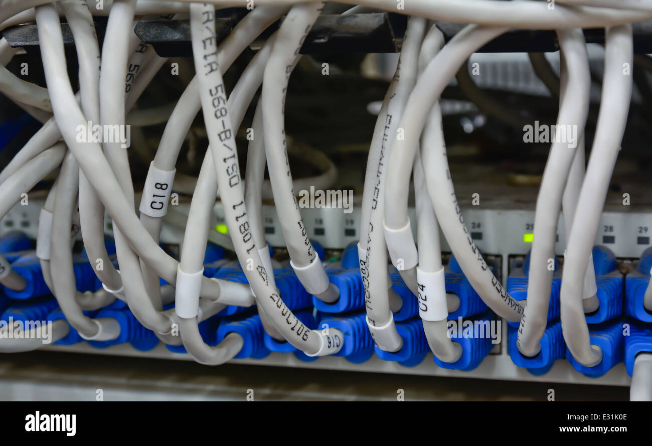 close-up of mess pattern ethernet cables connected to computer internet server Stock Photo