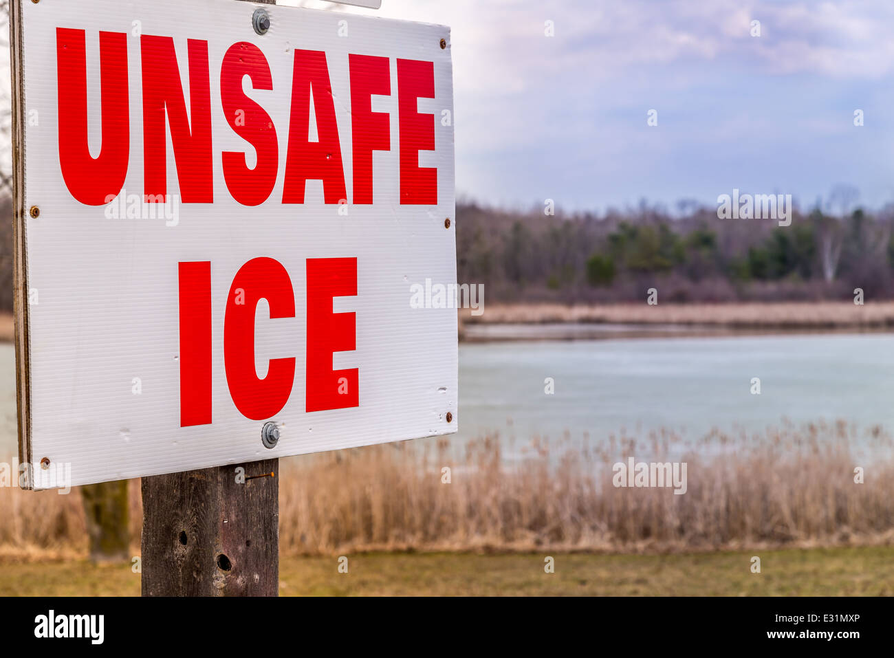 An unsafe ice sign posted near the edge of the Stouffville Reservoir. Stock Photo