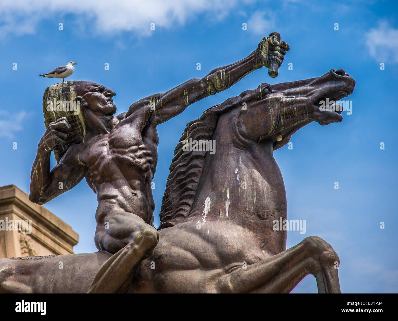 A bird sits on the head of The Bowman a bronze statue located in Chicago, USA at the intersection of Congress Drive and Michagan Ave. near Grant Park. Stock Photo