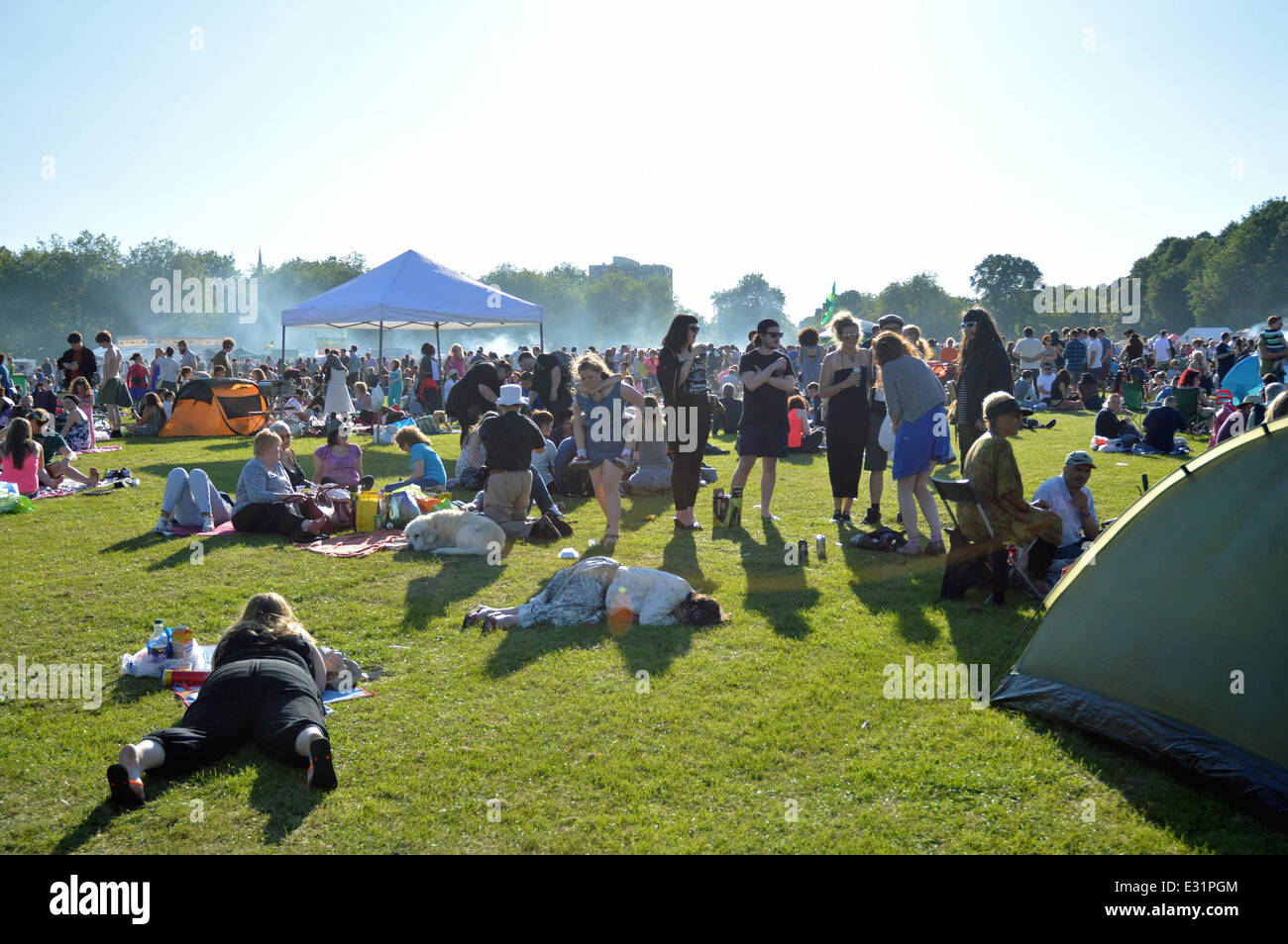 Festival goers enjoying the sunshine at the Africa Oye music festival in Sefton Park,Liverpool.Africa Oye is the largest free African music festival in the UK. Stock Photo