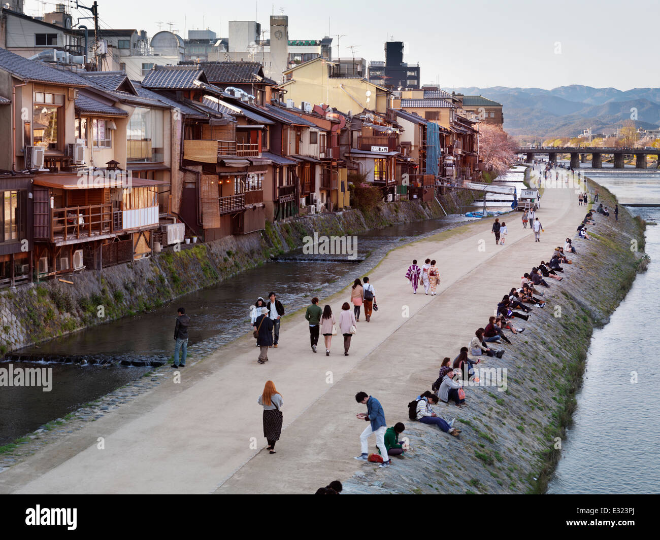 People walking along Kamo River in Kyoto, Japan 2014 Stock Photo