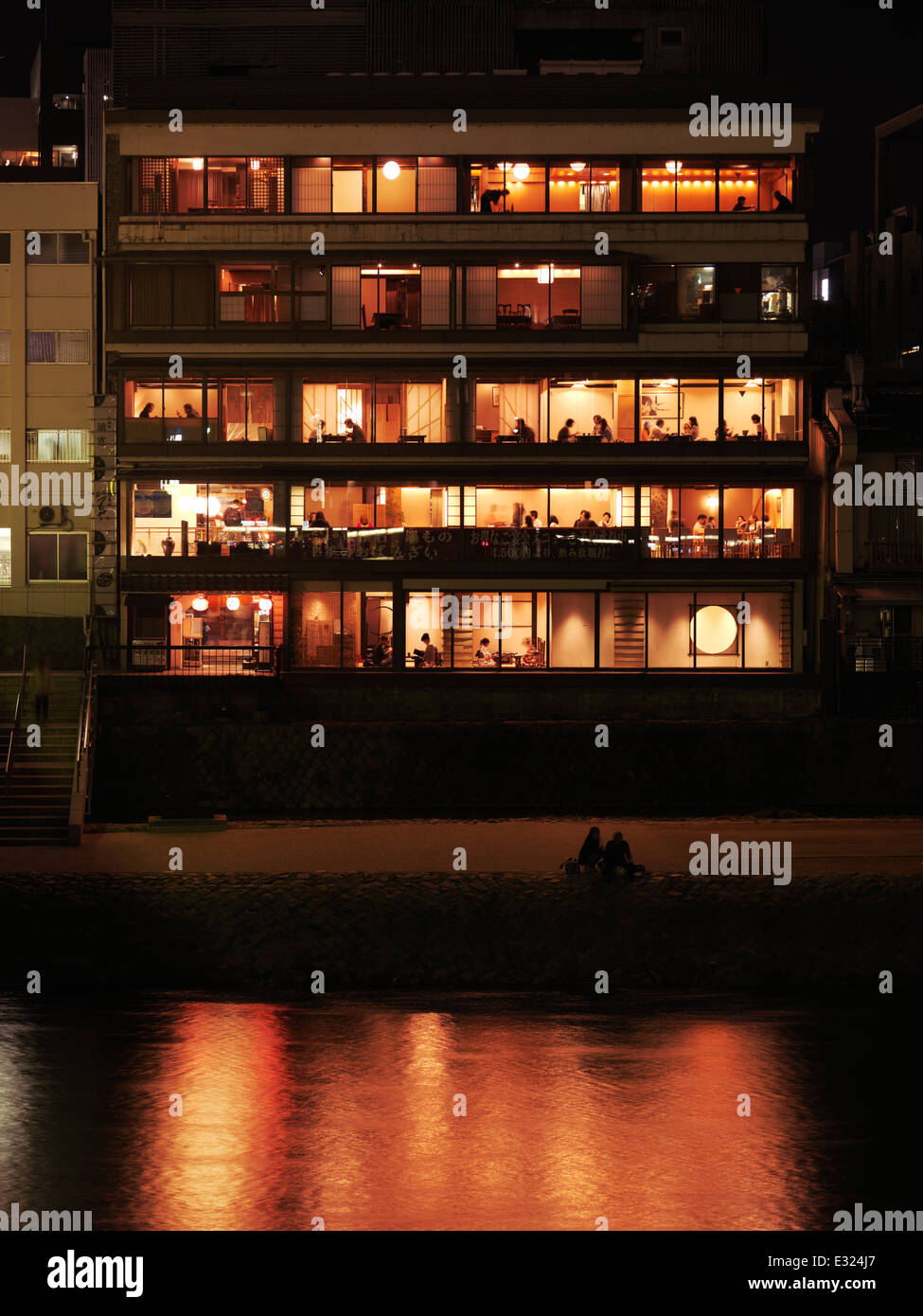 Japanese restaurant windows at night and Kamo River in Pontocho, Kyoto 2014 Stock Photo