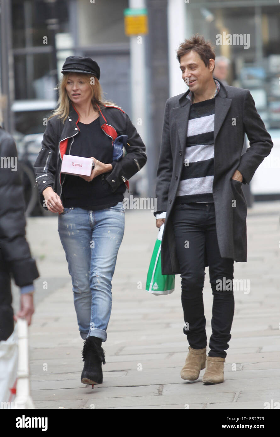 Kate Moss and husband, Jamie Hince stop off to buy a crepe from a stall while walking through Hampstead. The same stall was visi Stock Photo