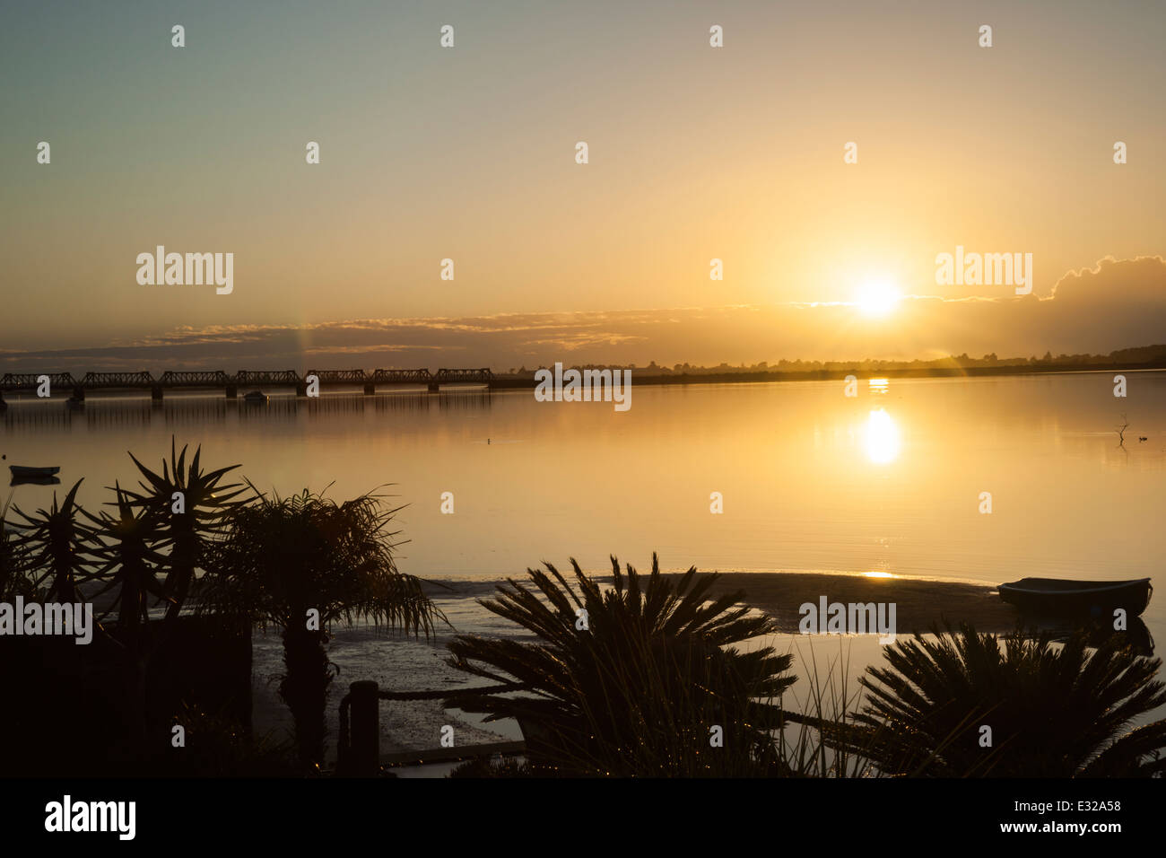 Golden sunrise over bay Stock Photo - Alamy