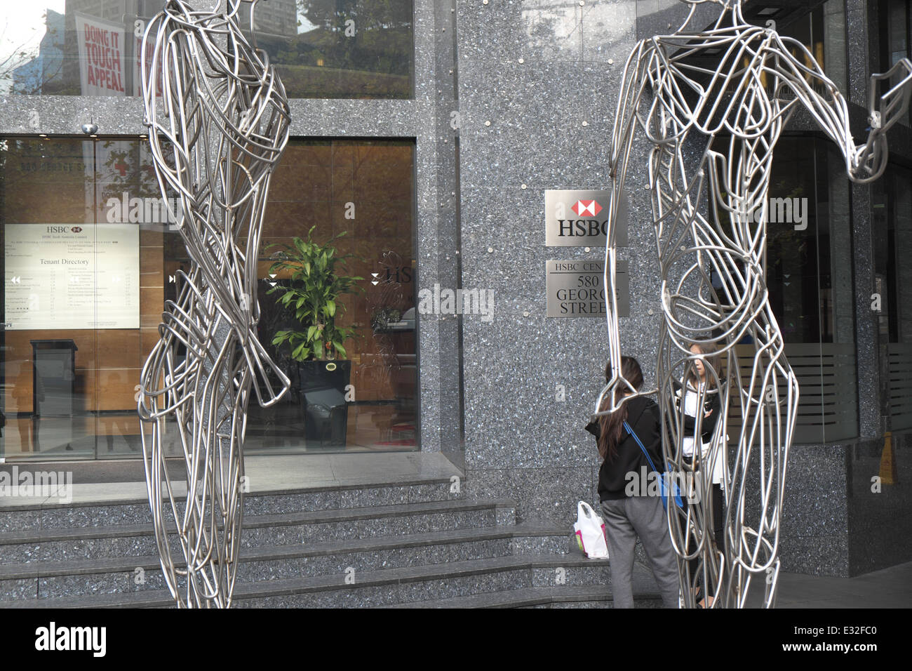 two asian girls outside offices of HSBC bank in sydney's george street,nsw,australia Stock Photo