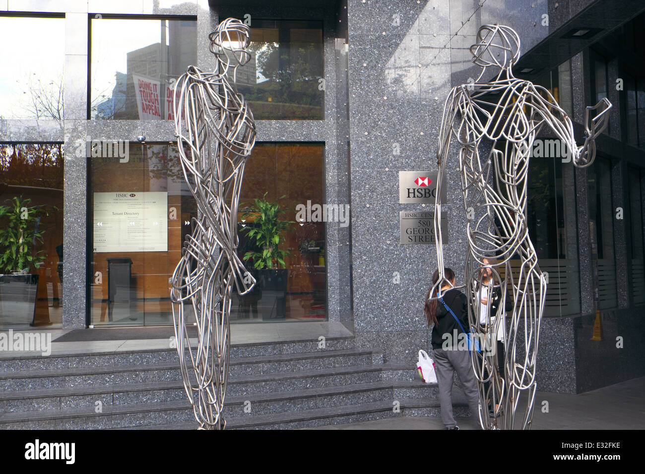 two asian girls outside offices of HSBC bank in sydney's george street,nsw,australia Stock Photo