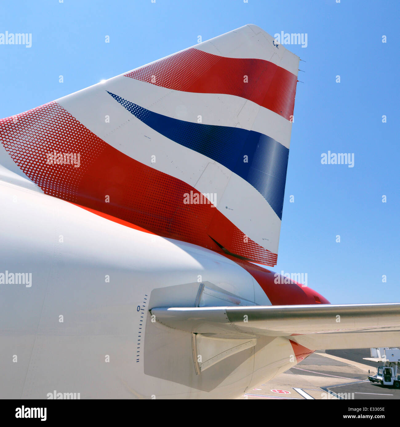 Close up of plane with red white blue British Airways corporate business BA logo on airplane tail fin against blue sky at Rome Airport Italy Stock Photo