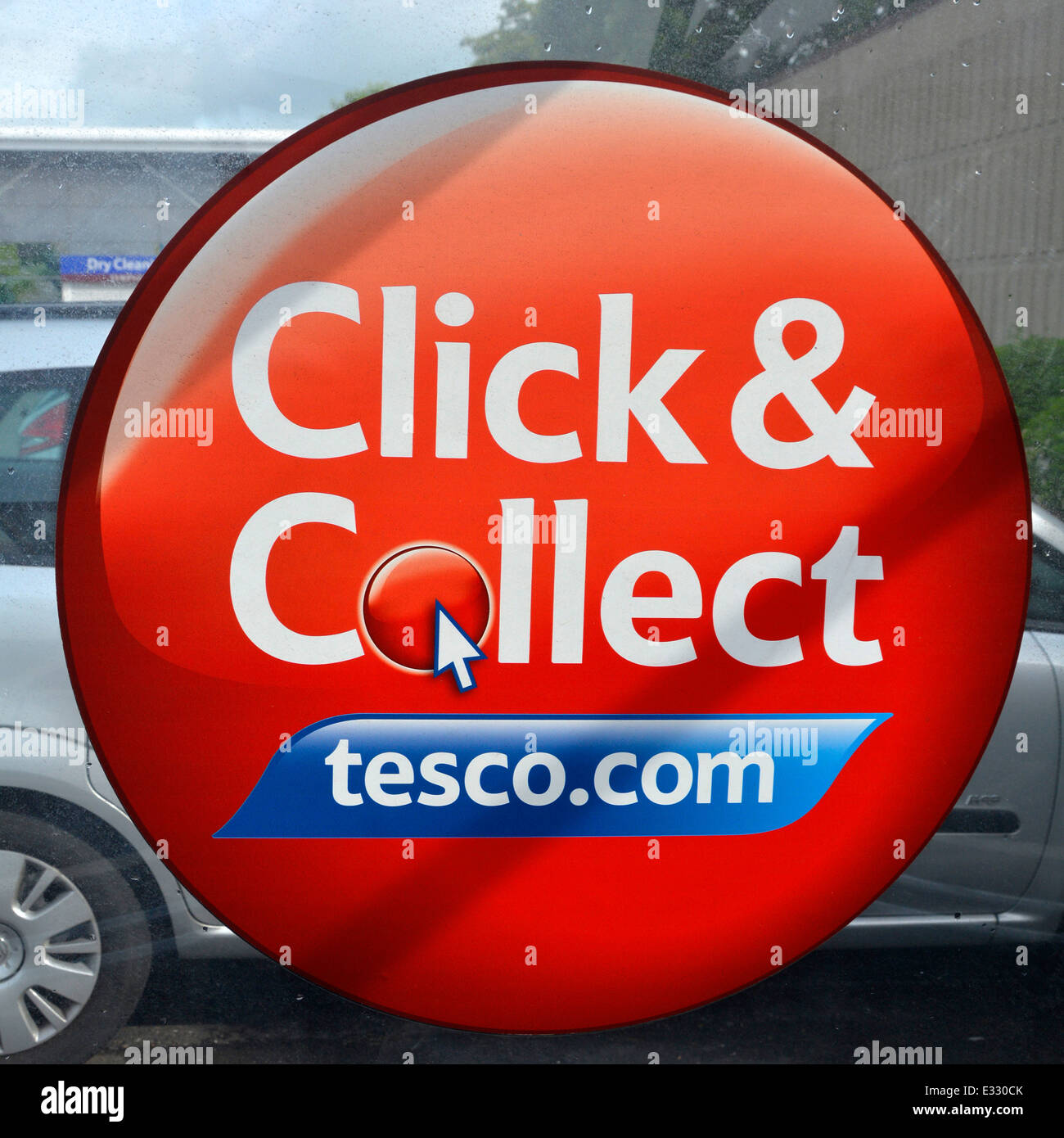 Tesco click and collect sign in trolley bay in supermarket car park Romford Greater London England UK Stock Photo