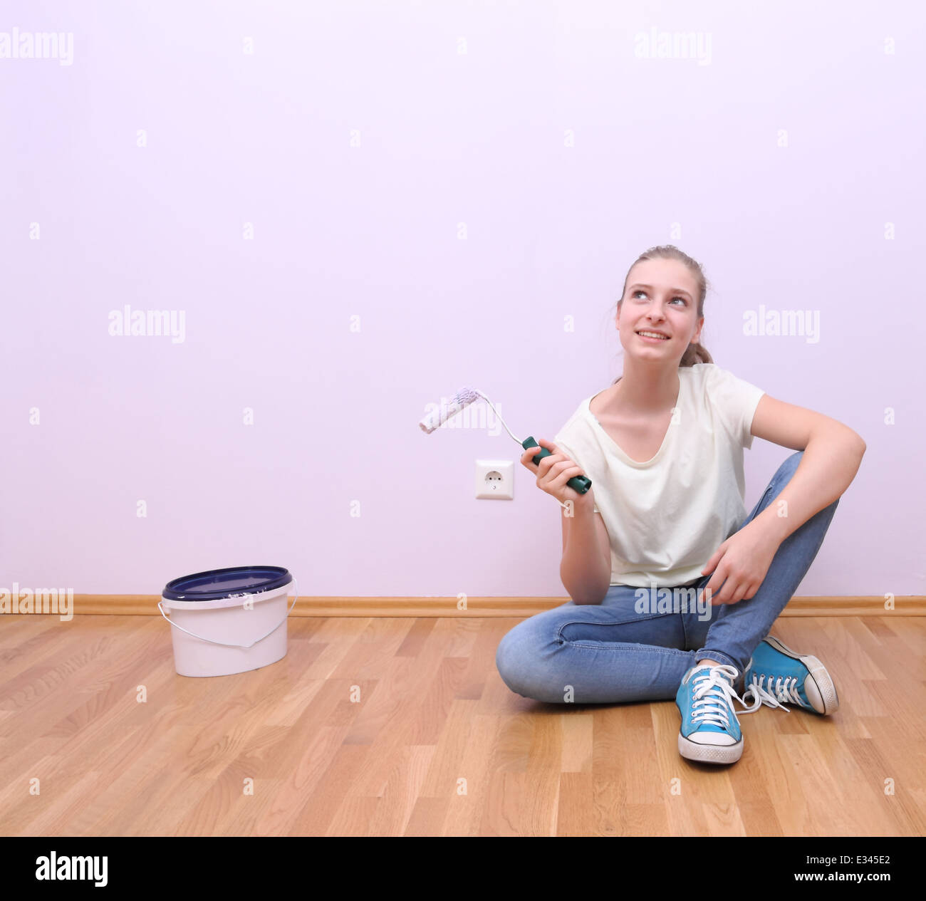 Dreaming girl in house renovation, lilac color, horizontal Stock Photo
