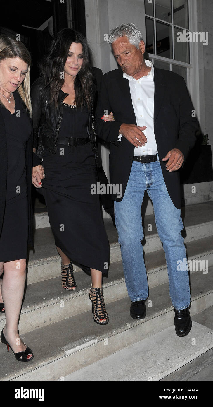 Sandra Bullock appears a little unsteady on her feet as she leaves 34  restaurant in Mayfair, and is held up by two assistants as she walks down  the steps to her waiting