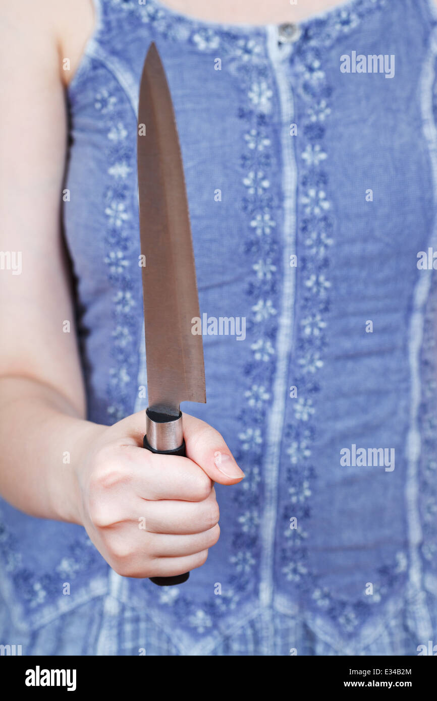 Woman holding large kitchen knife hi-res stock photography and images ...