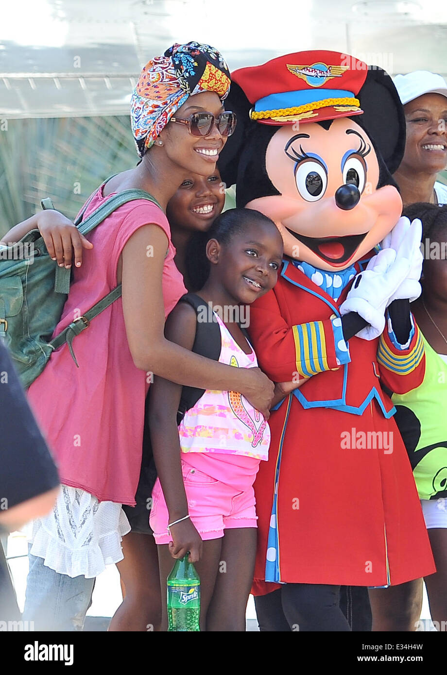 Brandy Norwood poses with Minnie Mouse and her family during a visit to