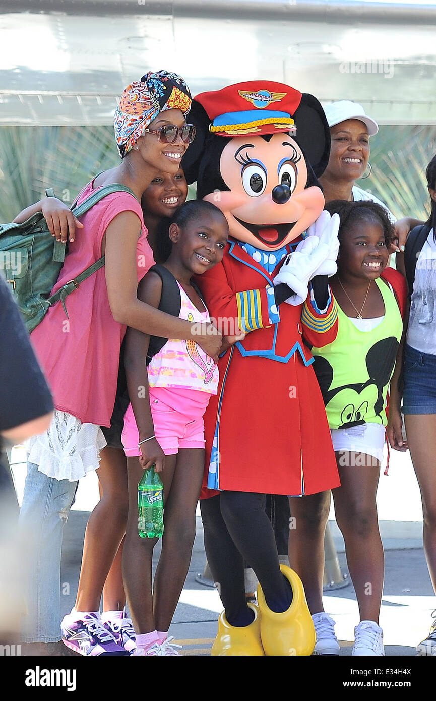 Brandy Norwood poses with Minnie Mouse and her family during a visit to Disneyland. Brandy's