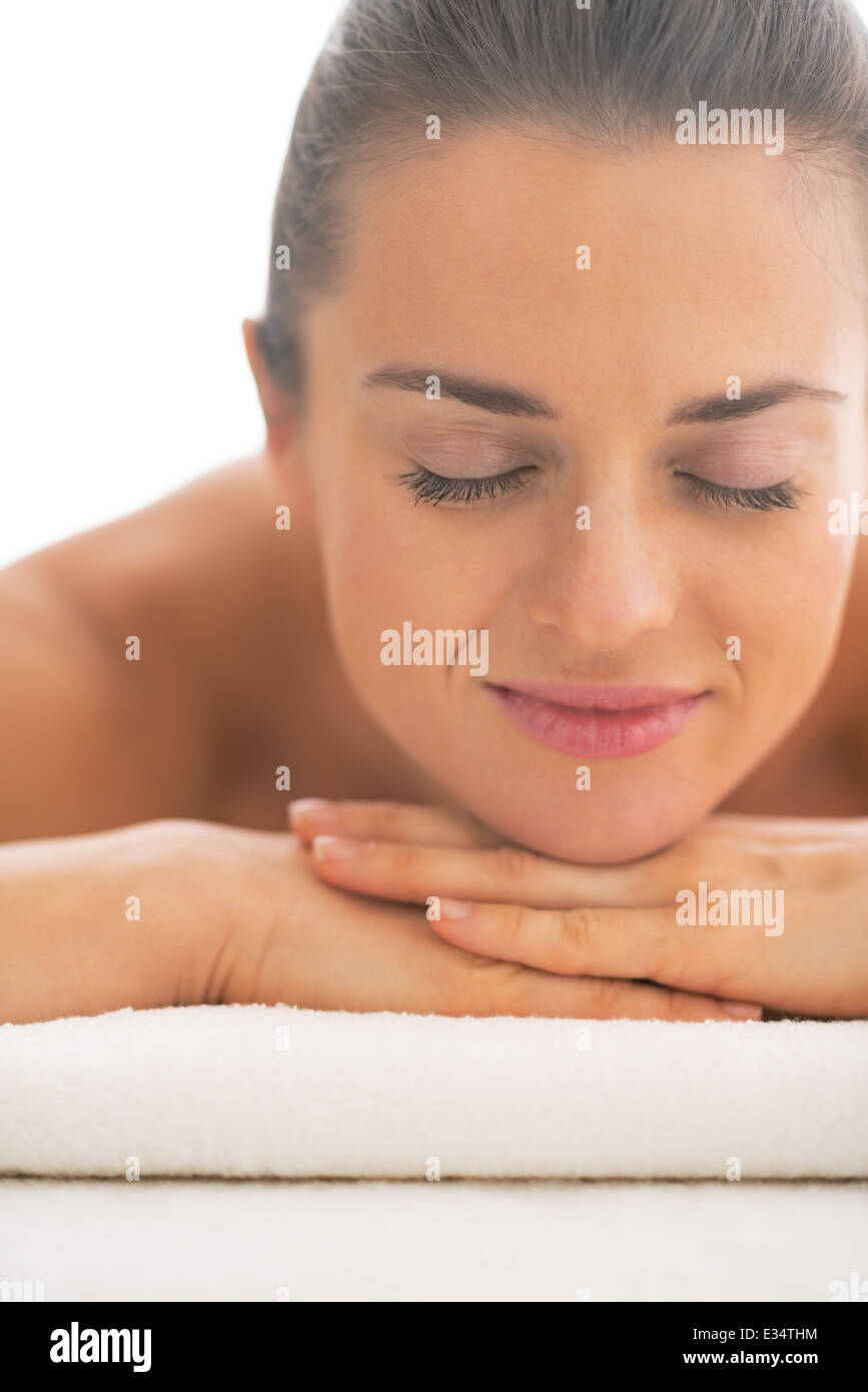 Portrait of young woman laying on massage table Stock Photo