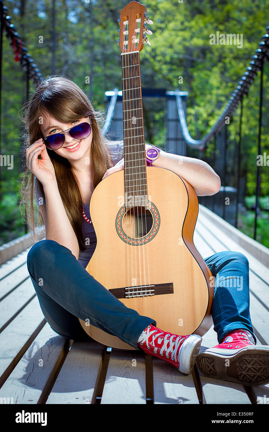 Cute teenager girl playing the guitar Stock Photo - Alamy