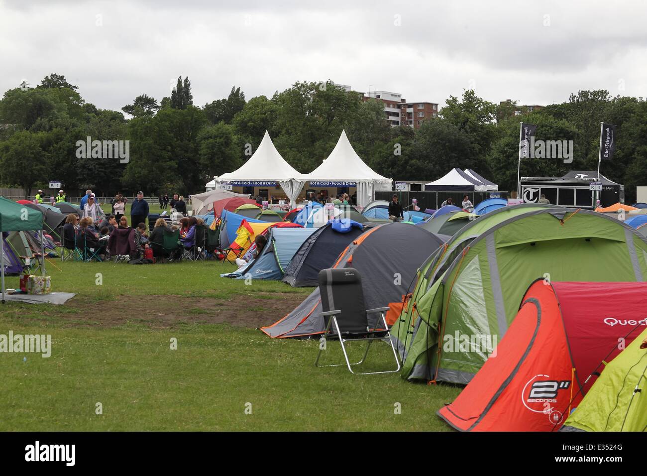 Tennis fans camp out at Wimbledon ahead of the opening day of the 2013 All England Lawn Tennis Championships. Some campers pass the time by playing their own form of tennis on the playing fields opposite.  Where: London, United Kingdom When: 23 Jun 2013 Stock Photo