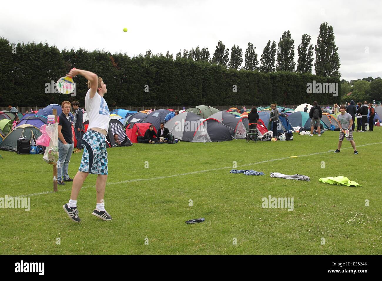 Tennis fans camp out at Wimbledon ahead of the opening day of the 2013 All England Lawn Tennis Championships. Some campers pass the time by playing their own form of tennis on the playing fields opposite.  Where: London, United Kingdom When: 23 Jun 2013 Stock Photo