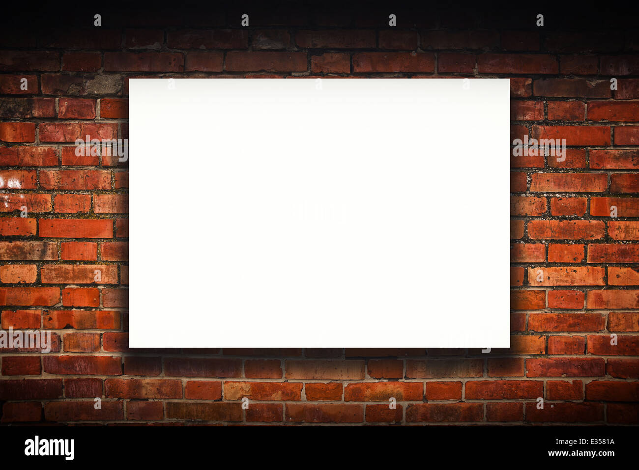Blank poster on old brick wall. Outdoor advertising copy space. Stock Photo