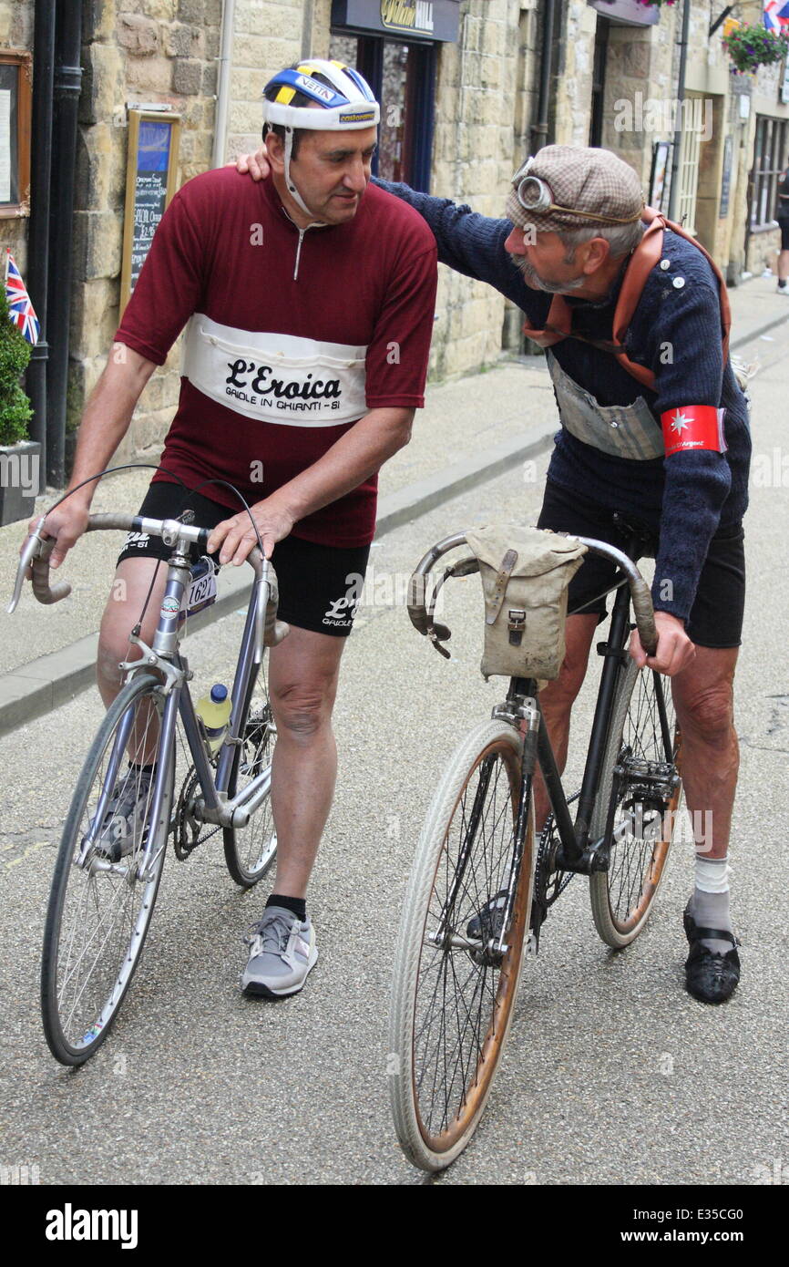 Bakewell, Derbyshire, UK. 22nd June, 2014.Ê L'Eroica legend, Luciano Berruti (right), 72, from Italy joins the starting point of the most handsome bike ride in the world on his 1907 Peugeot bicycle ahead of his 55 mile tour of the Peak District.Ê Luciano, who has participated in every L'Eroica since it began in 1997 in Italy is one of 2, 000 cyclists riding pre-1987 road bikes, wearing vintage kit on the third and final day of L'Eroica Britannia, a three day vintage cycling festival with a 30, 55 or 100 miles cycling tour at its heart. Credit:  Matthew Taylor/Alamy Live News Stock Photo