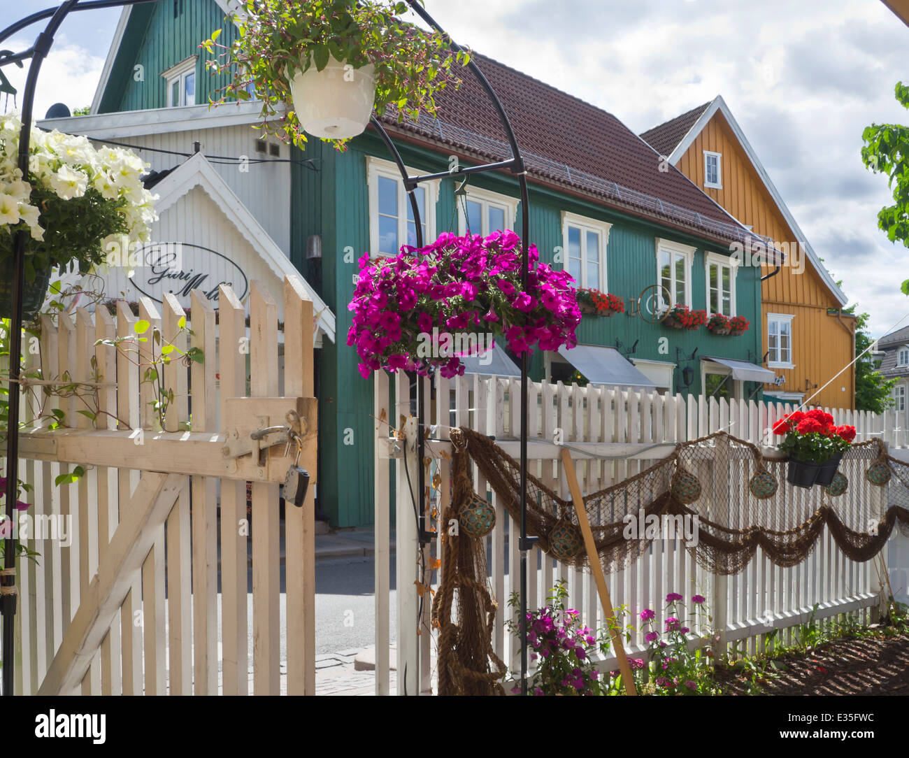 Flowerpots, glass floats and fishing net on a picket fence, rustic  decoration in an outdoors restaurant in Drobak Norway Stock Photo - Alamy