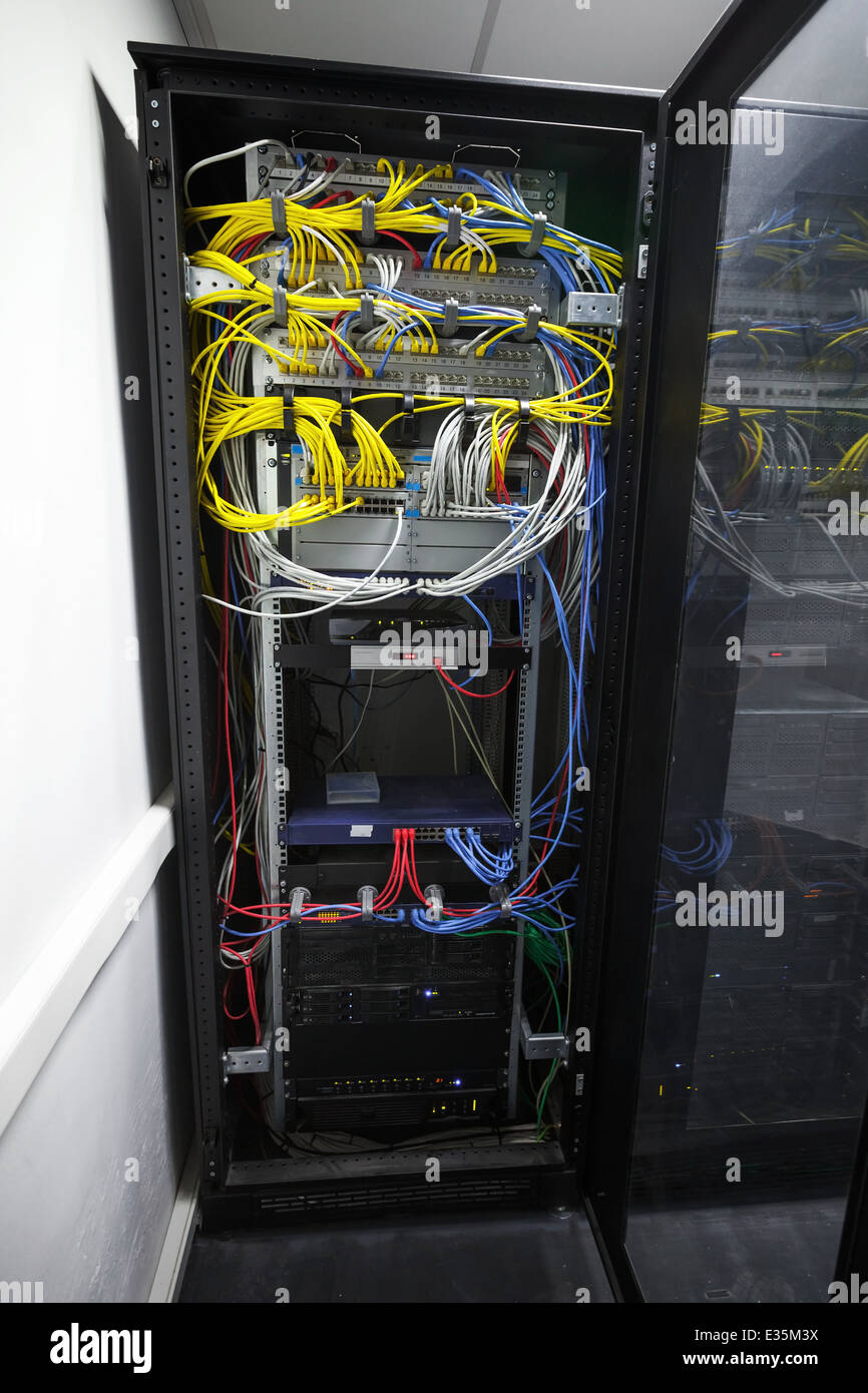 Modern black server cabinet with network equipment and wires Stock Photo