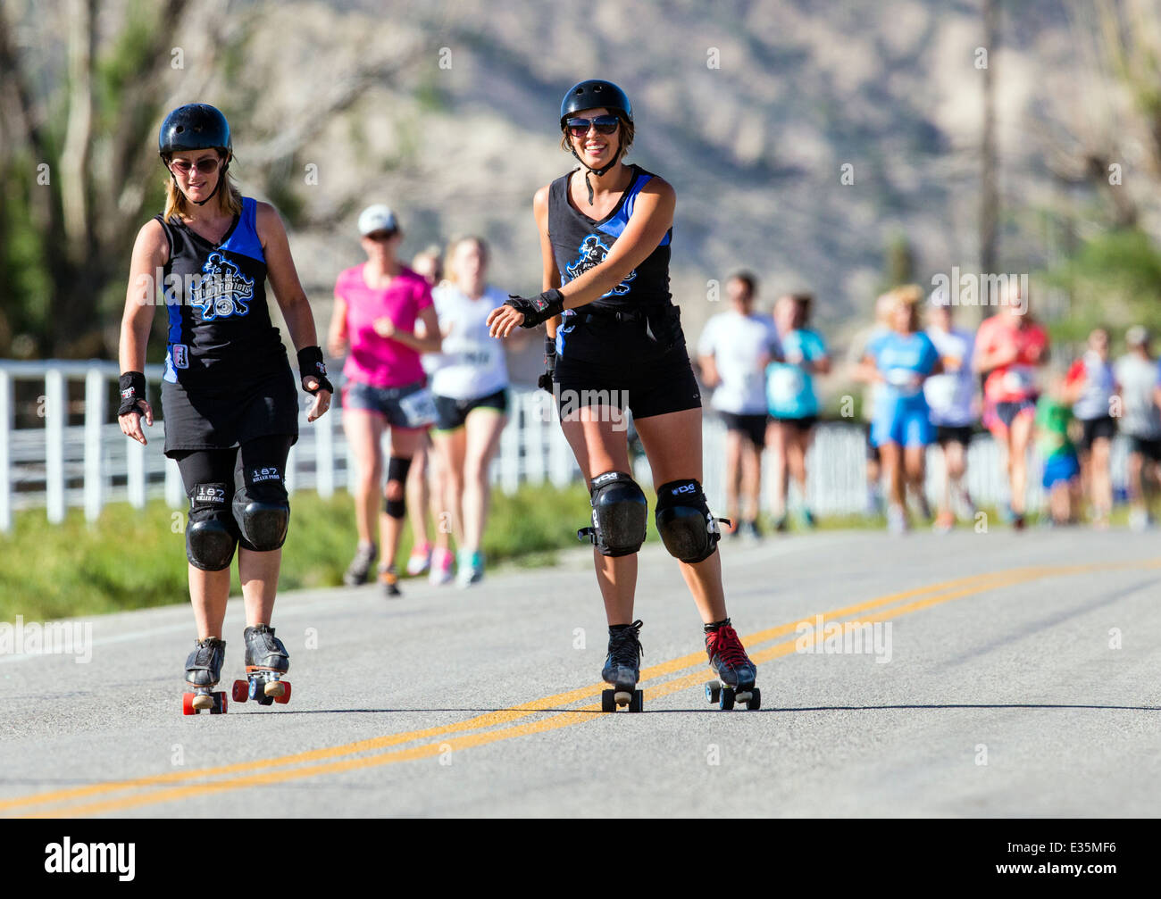 Roller derby women skate in a 5K & 10K foot race, annual Fibark festival, Salida, Colorado, USA Stock Photo