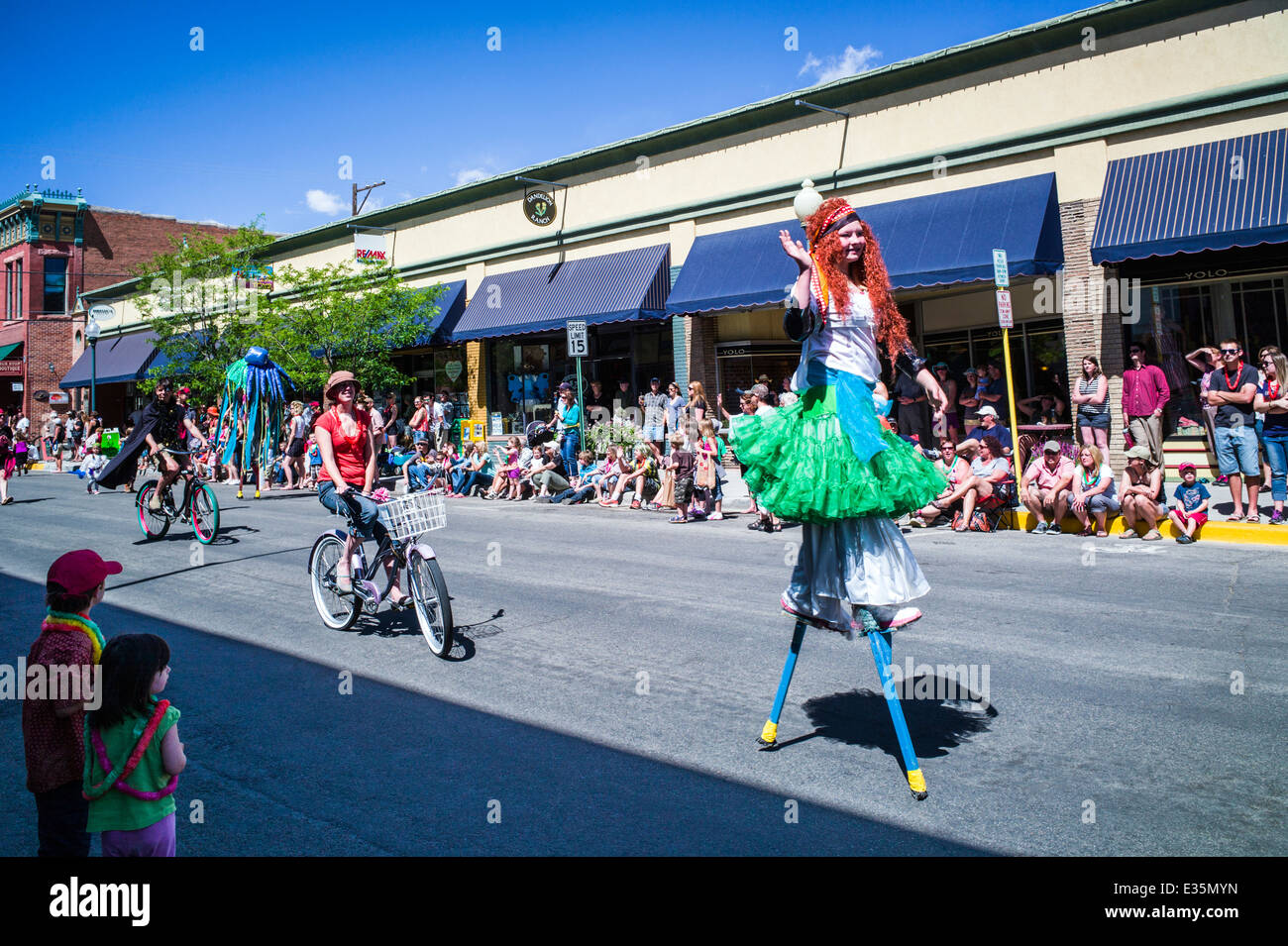 Circus performers on stilts in Annual FIBark Parade in small mountain town of Salida, Colorado, USA Stock Photo