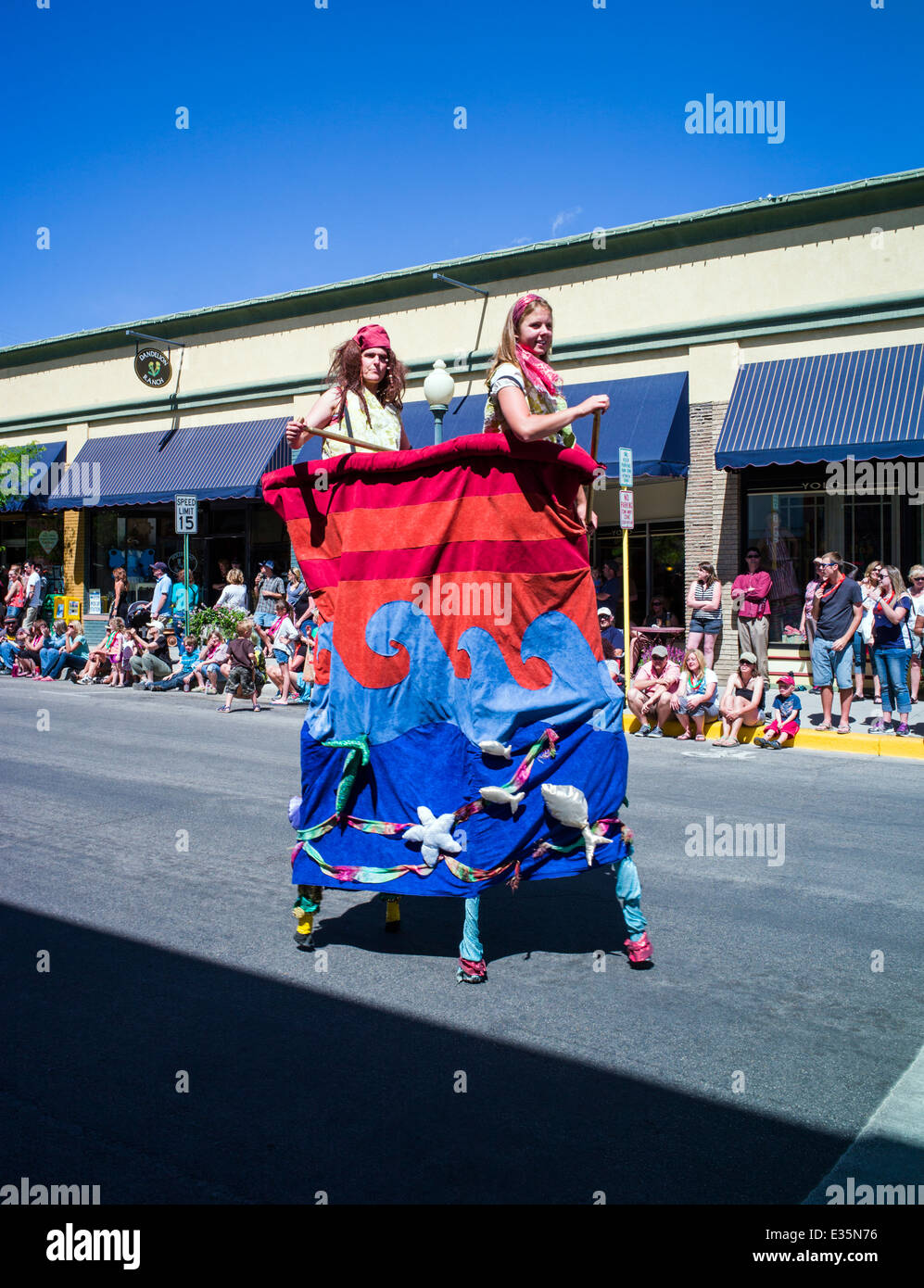 Circus performers on stilts in Annual FIBark Parade in small mountain town of Salida, Colorado, USA Stock Photo